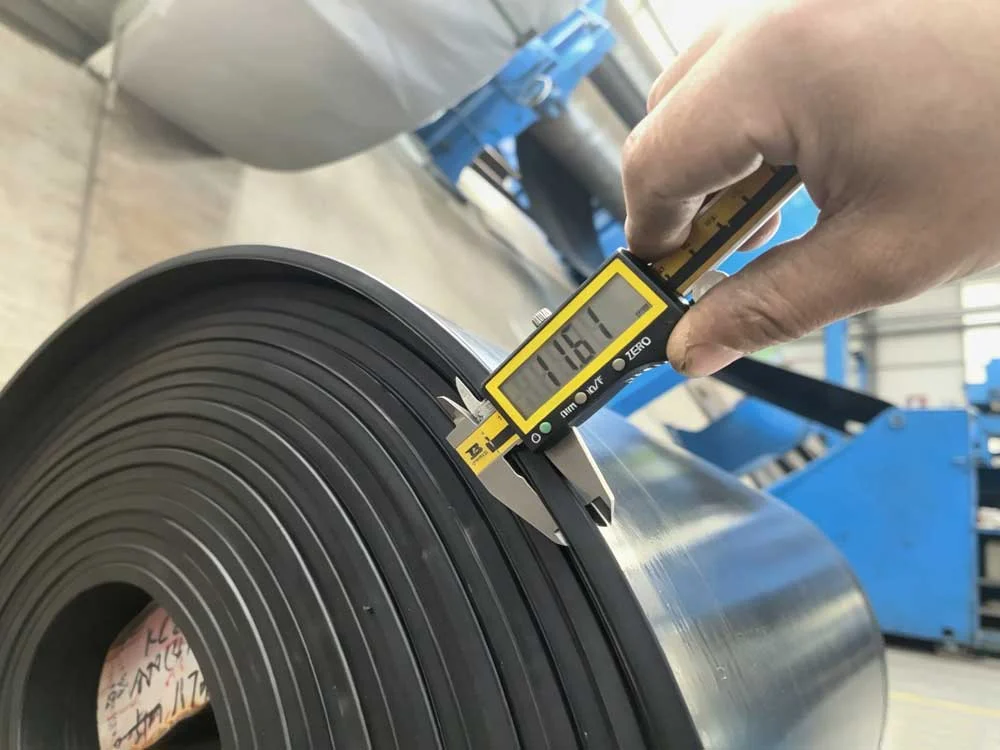 Rubber conveyor belt testing: measuring belt thickness with a precise caliper for quality assurance